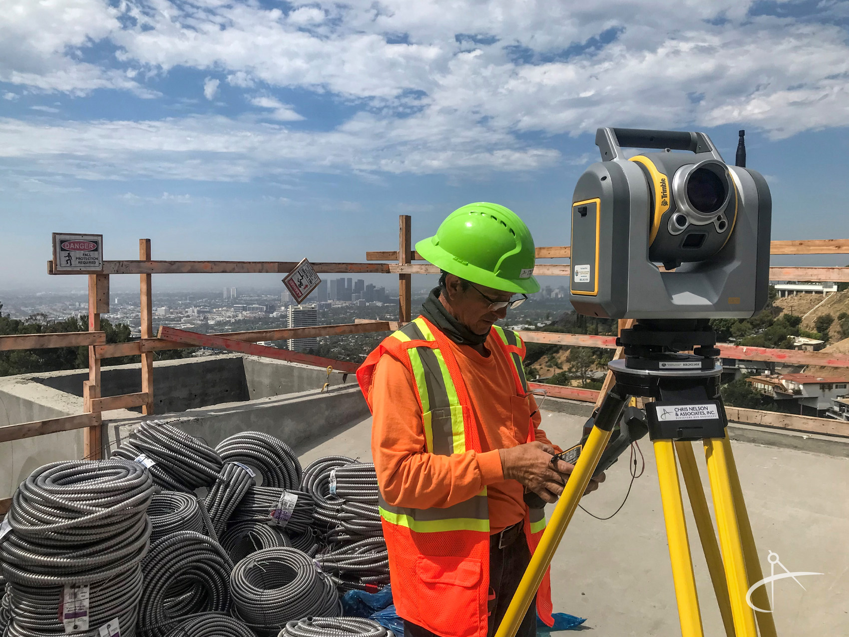 Surveyor using Trimble SX-10 Scanner at a construction site.